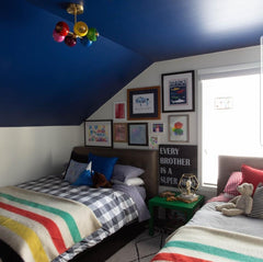 Boys bedroom with rainbow chandelier blue ceiling 