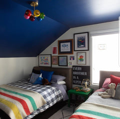 Boys bedroom with rainbow chandelier blue ceiling