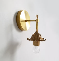 Brass floral wall sconce with cast brass detailing.  Modern take on traditional style brass light fixtures that retails old-world European charm with the finial and brass flower. Octavia wall sconce made by Sazerac Stitches in New Orleans