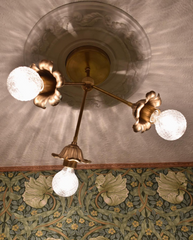brass floral small chandelier in an art deco inspired closet