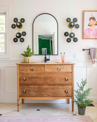 Black and brass eclectic wall sconces for a bathroom renovation