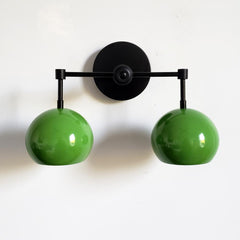 Green and black two light all sconce for bathroom vanity, above shelf lighting, etc.