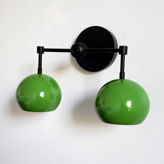 Green and black two light all sconce for bathroom vanity, above shelf lighting, etc.