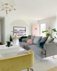 Brass and glass chandelier in a mid century modern inspired living room