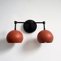 black and terra cotta two light wall sconce boho style