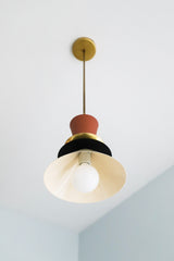 Neutral space style pendant with terra cotta, black, and cream accents