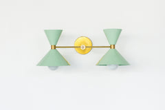 Mint & Brass two light modern wall sconce by Sazerac stitches.  Features mid century modern shades.  two light vanity light