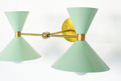 Mint & Brass two light modern wall sconce by Sazerac stitches.  Features mid century modern shades.  two light vanity light