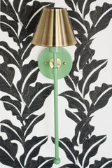 Vintage green and brass colorful bathroom wall sconce on a black and white floral wallpaper
