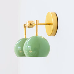 Pastel Green and brass two light mid century modern wall sconce