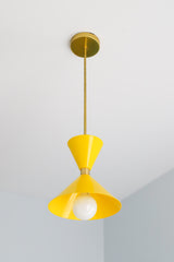 yellow and brass mid century modern inspired pendant light fixture for kitchen island design