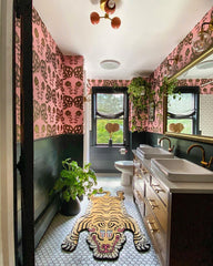 Boho Eclectic bathroom with wood vanity, tiger rug, and pink wallpaper
