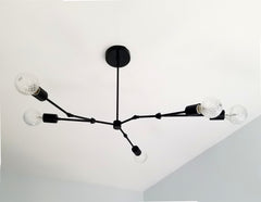 Black modern asymmetric chandelier lighting mid century organic design home renovation dining room