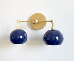 raw brass and navy shade wall lighting