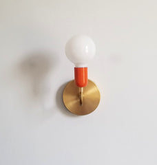 mid century modern brass and orange wall sconce lighting bathroom