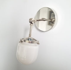 chrome single wall sconce with a white shade