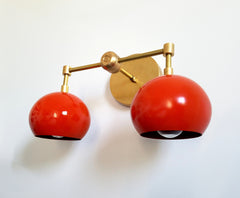 orange and brass wall sconce with globes shades