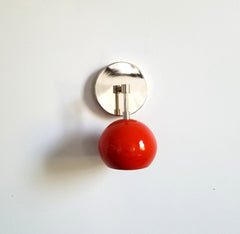 modern chrome and orange wall sconce with eyeball shade
