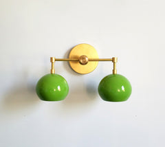 Green and brass two light bathroom wall sconce