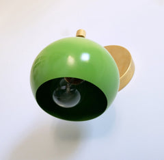 bottom view of the green and brass loa wall sconce