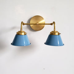 light blue and brass two light wall sconce with mid century modern cone shades perfect for bathroom vanity lighting