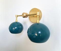 teal and brass two-light vanity fixture midcentury modern