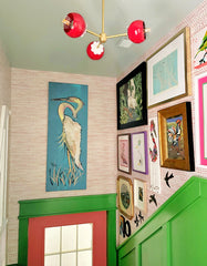 Colorful hallway with a red and brass small chandelier