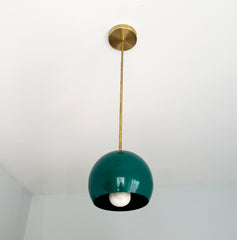 Brass and jewel tone green globe pendant lighting