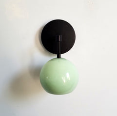 Mint and matte black single light wall sconce with a globe shade midcentury modern minimalism vanity task lighting