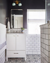 Modern farmhouse bathroom with mint and brass double loa sconce