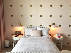 Pink Loa sconces with gold heart wallpaper