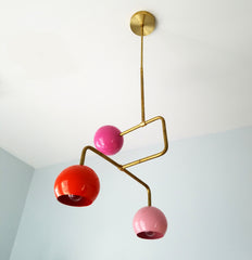 multicolored pink and gold mid century modern chandelier with colorful pink and orange globes