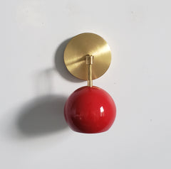 red and brass mid century modern globe wall sconce
