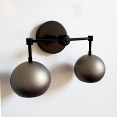 matte black and steel two light wall sconce for bathrooms, kitchens, bedrooms etc. Industrial style finishes with a mid century modern design