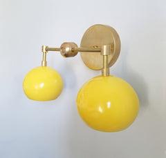 yellow and brass mid-century inspired modern wall sconce