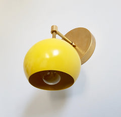 Yellow and Brass modern wall sconce lighting with an eyeball shade