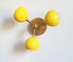 yellow and brass 3 light modern mid-century inspired sconce