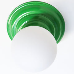 Stepping back into a bygone era with a touch of modern minimalism, the Abeille Sconce or Flushmount in bright green is an artistic blend of form and function. This wall sconce doubles as a flushmount ceiling light, making it a versatile lighting solution for any space. Designed akin to a beehive, its charismatic shape is complemented by curated color options that add a playful element to its retro appeal.