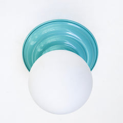 Stepping back into a bygone era with a touch of modern minimalism, the Abeille Sconce or Flushmount in tiffany blue poolside aqua color  is an artistic blend of form and function. This wall sconce doubles as a flushmount ceiling light, making it a versatile lighting solution for any space. Designed akin to a beehive, its charismatic shape is complemented by curated color options that add a playful element to its retro appeal.