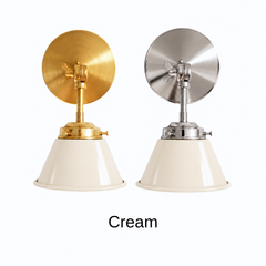 A cream wall sconce with a glossy cone shade, shown in Cream with brass or nickel hardware. It has a single light, a round backplate, and a swivel knuckle with a wing nut so you can tilt the shade toward a bed, a mirror, or a sink. Hang one by a bed, a pair beside a bathroom mirror as a vanity light, or one over a kitchen sink. Warm off white pairs well with unlacquered brass, butcher block, and checkered tile, so it suits English cottage, vintage kitchen, and warm neutral rooms.