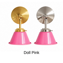 A hot pink wall sconce with a glossy cone shade, shown in Doll Pink with brass or nickel hardware. It has a single light, a round backplate, and a swivel knuckle with a wing nut so you can angle the shade where you need it. Hang one by a bed as a reading light, a pair on either side of a bathroom mirror as a vanity light, or one over a desk. Bright pink looks great against green or orange walls and bold wallpaper, so it fits maximalist, playful, and pink bedroom decor.