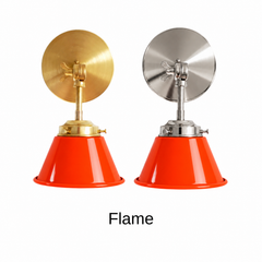 A red orange wall sconce with a glossy cone shade, shown in Flame with brass or nickel hardware. It has a single light, a round backplate, and a swivel knuckle with a wing nut so you can aim the shade where you need it. Mount one over a kitchen counter, a pair by a bathroom mirror as a vanity light, or one next to a sofa for reading. Red orange looks great with teal or cobalt walls, terrazzo, and walnut, so it suits mid century modern, 70s inspired, and eclectic rooms.