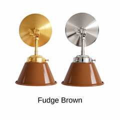 A caramel brown wall sconce with a glossy cone shade, shown in Fudge Brown with brass or nickel hardware. It has a single light, a round backplate, and a swivel knuckle with a wing nut so you can aim the shade where you need it. Use it as a bedside reading light, a vanity light next to a bathroom mirror, or a task light in a study or den. Warm brown pairs well with cream, olive, and rust, plus leather and walnut, so it suits 70s inspired, mid century modern, and cozy traditional rooms.