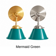 A deep emerald wall sconce with a glossy cone shade, shown in Mermaid Green with brass or nickel hardware. It has a single light, a round backplate, and a swivel knuckle with a wing nut so you can aim the shade where you need it. Mount a pair by a bathroom mirror as a vanity light, one by a bed for reading, or one over a bar cart. Deep teal sits well with coral or mustard accents, velvet, and dark wood, so it suits coastal, jewel tone, and mid century modern decor.