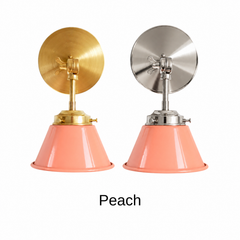 A peach coral wall sconce with a glossy cone shade, shown in Peach with brass or nickel hardware. It has a single light, a round backplate, and a swivel knuckle with a wing nut so you can tilt the shade toward a bed, a mirror, or a sink. Use it as a bedside sconce in a bedroom or nursery, a vanity light in a powder room, or a pair in a breakfast nook. Peach looks good with sage or cream walls, terracotta tile, and warm brass, so it suits coastal, cottage, and soft modern rooms.