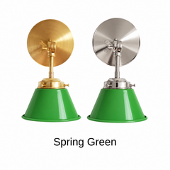 A kelly green wall sconce with a glossy cone shade, shown in Spring Green with brass or nickel hardware. It has a single light, a round backplate, and a swivel knuckle with a wing nut so you can tilt the shade toward a bed, a mirror, or a counter. Use it as a bedside reading light, a vanity light in a bathroom, or a pair over a kitchen sink. Bright green pairs well with pink or white walls, rattan, and striped wallpaper, so it suits preppy, Palm Beach, and colorful modern rooms.