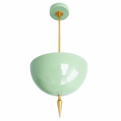 Mint green pendant light with a brass spike finial, the Alexander Pendant sends light up instead of down, so the glossy mint dome bounces a soft glow off the ceiling. That uplight pendant design paired with the oversized art deco spike gives it real presence without feeling heavy, a fresh, playful take on maximalist lighting. Statement dining room pendant, nursery ceiling light, or colorful entryway fixture for pastel traditional homes and anyone building a room with personality overhead.
