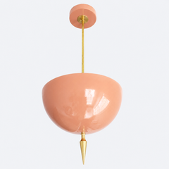 Peach pendant light with a brass spike finial, the Alexander Pendant sends light up instead of down, so the glossy peach dome bounces a soft, warm glow off the ceiling. That uplight pendant design paired with the oversized art deco spike gives it a feminine, maximalist edge, structured enough to anchor a room but soft enough to feel welcoming. Statement dining room pendant, nursery ceiling light, or colorful entryway fixture for grandmillennial homes and maximalist decor that wants warmth overhead.
