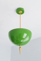 Handmade green pendant light in a fresh high-gloss finish. The  powder-coated dome is a lively spring green, warmed by a slim brass stem and a hand-turned brass spike finial that drops to a fine point. The color is crisp and glossy, a true grass-and-apple green that feels garden-fresh: it stays bright and leafy in daylight and glows softer under bulbs, playing beautifully against white walls, natural wood, or a botanical-print wallpaper. Perfect over a kitchen island, a breakfast nook, a sunroom, or an entr