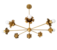 A large sculptural chandelier in warm brass, with eight arms splayed out asymmetrically from a central column, each one ending in a ruffled, flower-shaped bobeche holding an exposed globe bulb. The hand-finished petal detail gives it real old-house character instead of a flat industrial look, making it a strong anchor for a grand dining room, a formal entry, or any space that wants scale and warmth overhead. A ninth flower bobeche sits lower at the center for extra visual weight. Good for anyone searching f